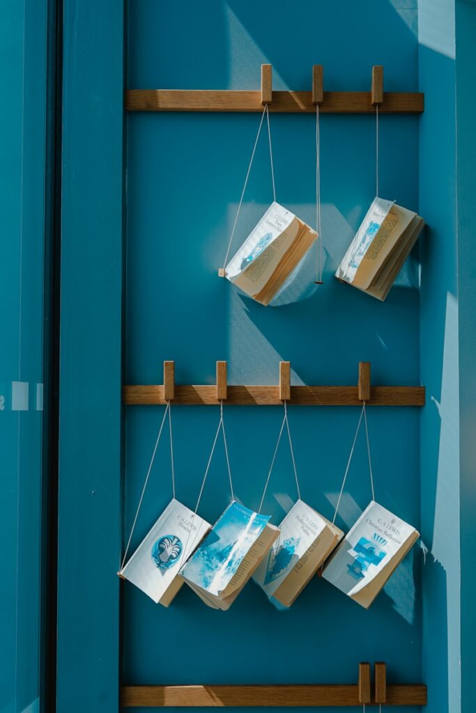 six hanging books on wall